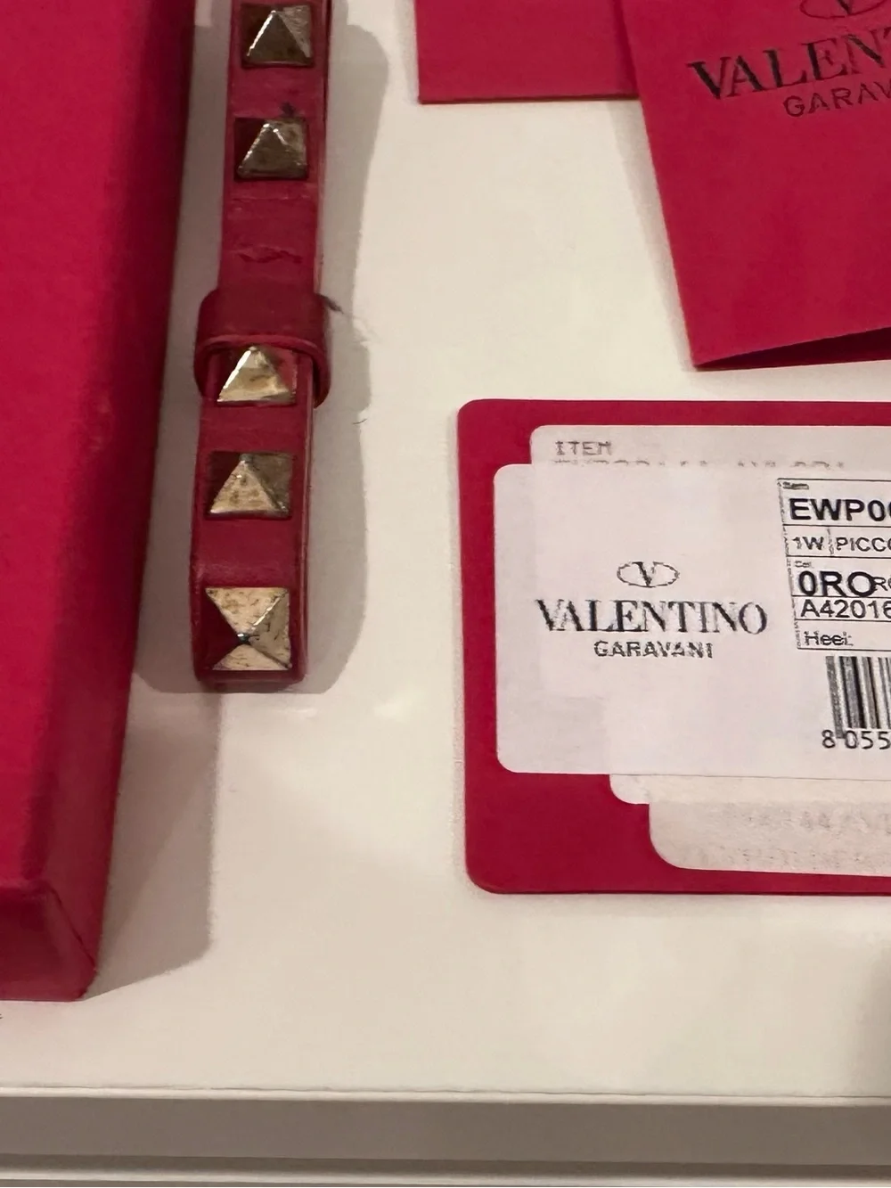 Valentino Garavani Rockstud Key chain Strap in Red with Gold Studs.